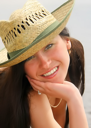 Brunette allows hot sun to caress her naked body.