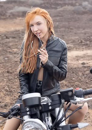 Lilly Mays Rides A Motorcycle In The Desert Wearing A Leather Jacket And Miniskirt