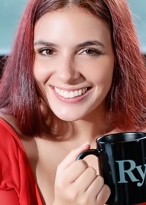 Ultravioleta lounges on the couch, topless in red lingerie, smiling with tattooed skin on display